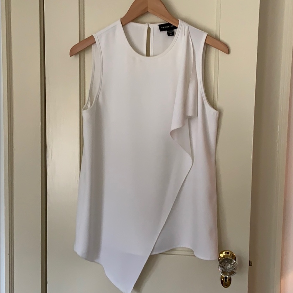 Crisp white, sleeveless top with perfect ruffle
